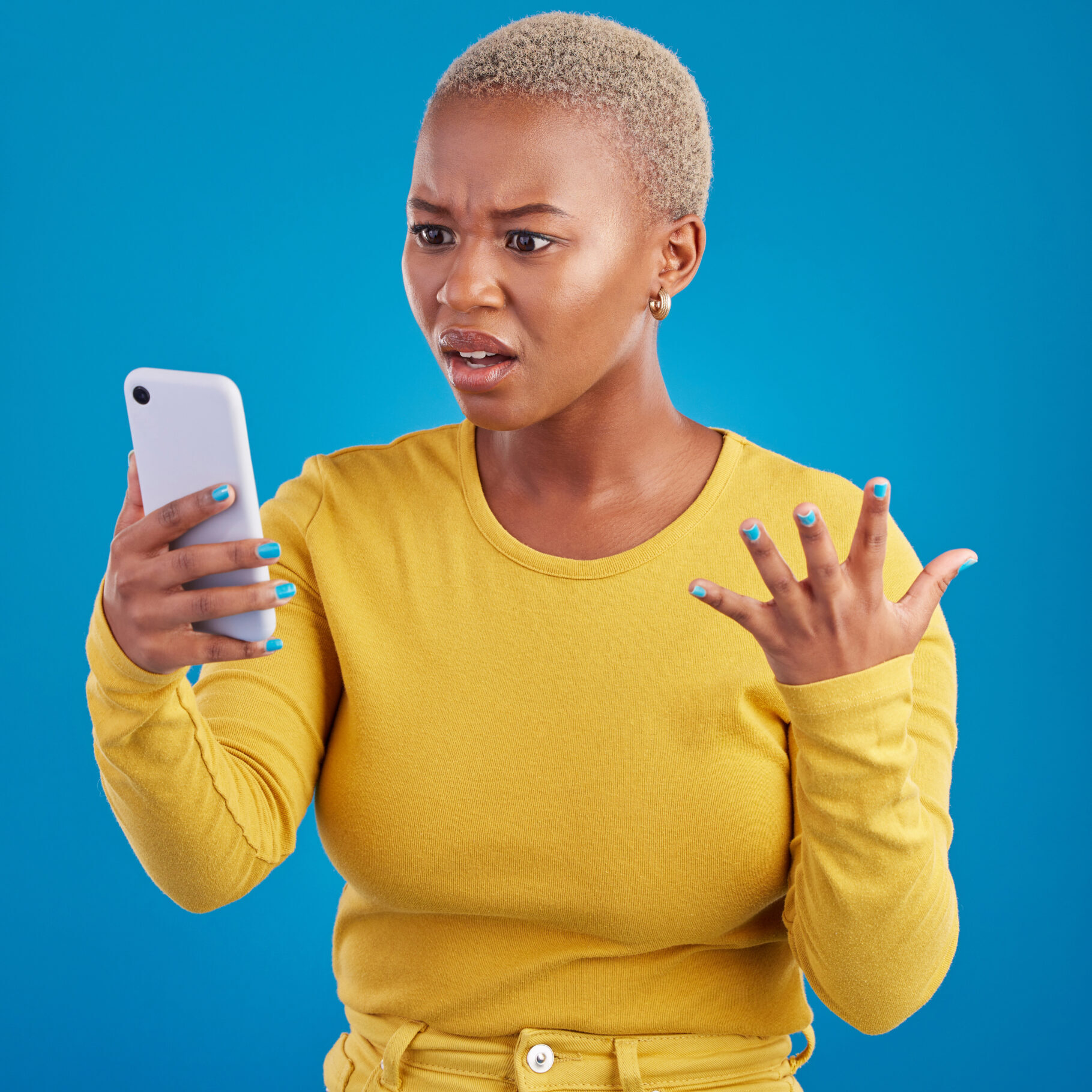 Phone, wtf and confused black woman in studio for fake news, social media and text on blue backgrou