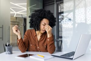 Stressed businesswoman feeling headache at work