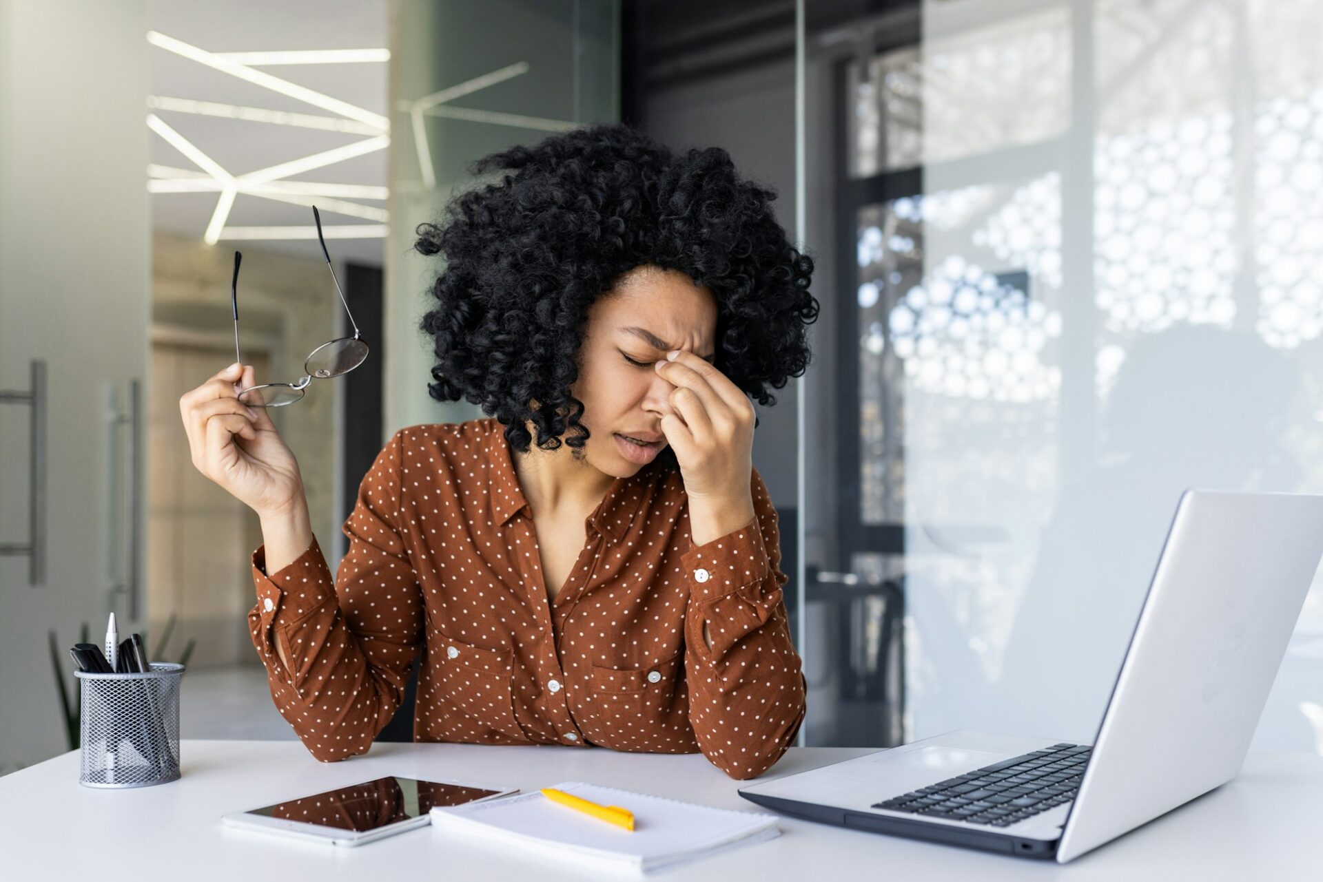 Stressed businesswoman feeling headache at work